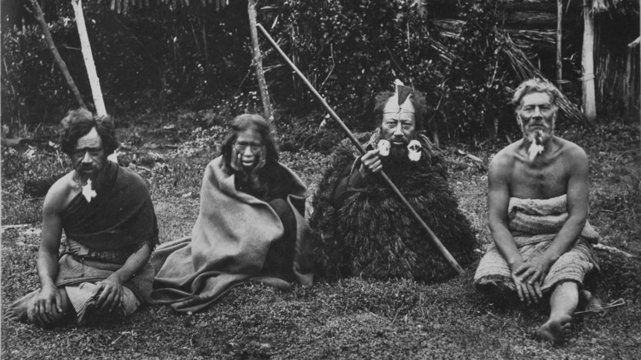 Tchakat Moriori sitting in front of hut, Rēkohu (Chatham Islands) 1877